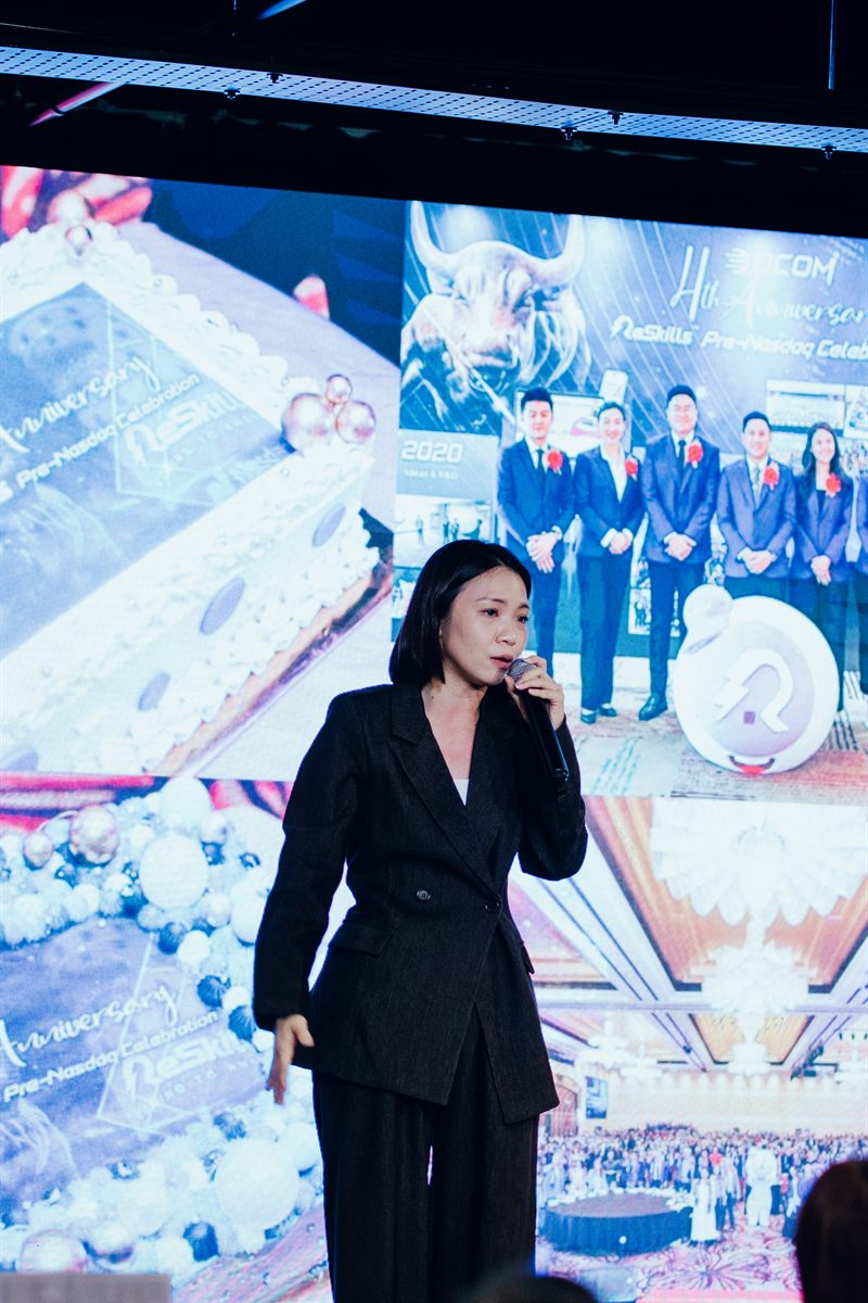 Yen speaking on stage